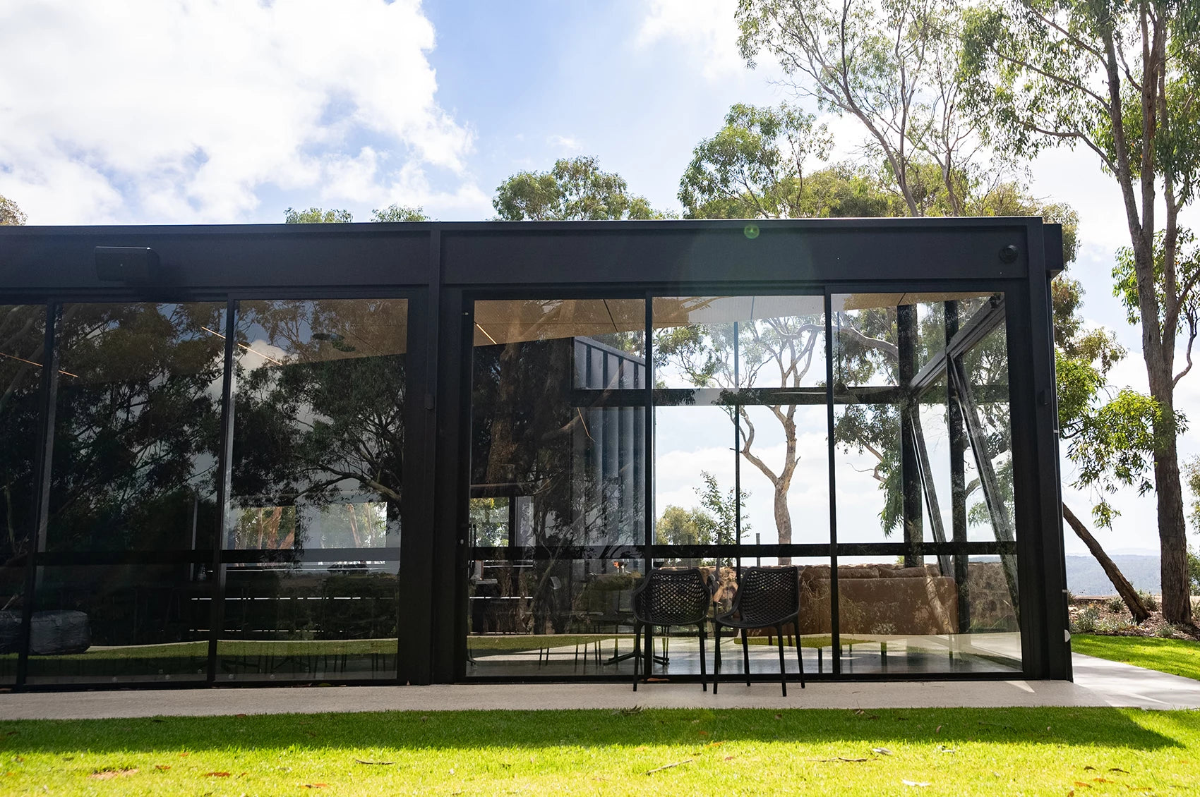 a black winery building with floor to ceiling windows in the adelaide hills