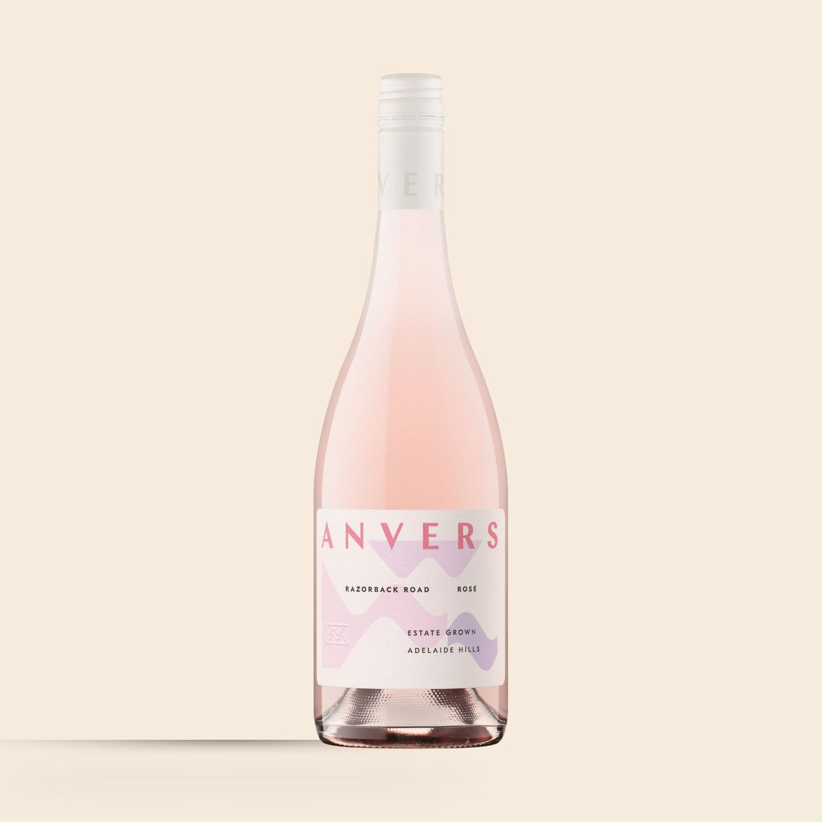 A bottle of 2025 Razorback Road Syrah Rosé wine with a pink label that matches the wine's color.